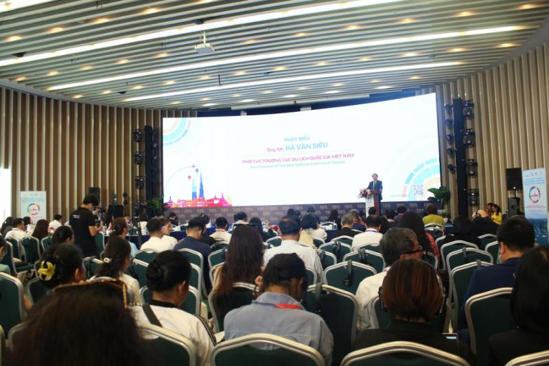Một buổi hội thảo với các chuyên gia đang thảo luận về chủ đề du lịch sinh thái bền vững, có người phát biểu và khán giả lắng nghe